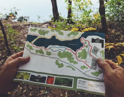 A person holding up a map of a trail in the woods for career planning.