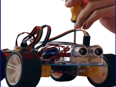 A person is working on a toy car.