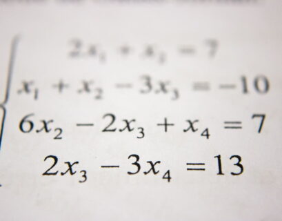 A close up of a paper with a number of equations on it.