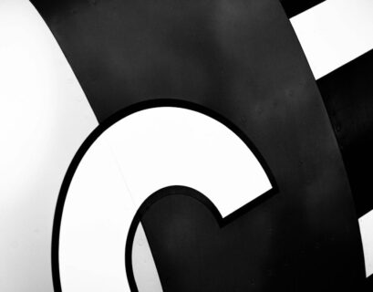 A black and white photo of a sign with the letter c.